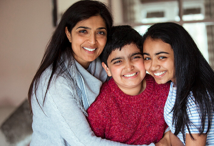 Family with two children, smiling and hugging